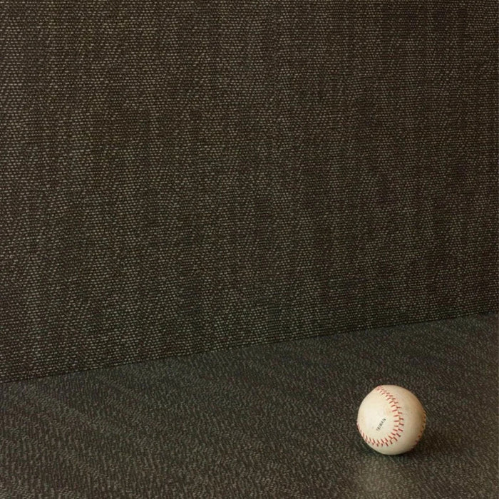 A close-up of a dark charcoal gray textured tile with a baseball in the lower right corner for scale.