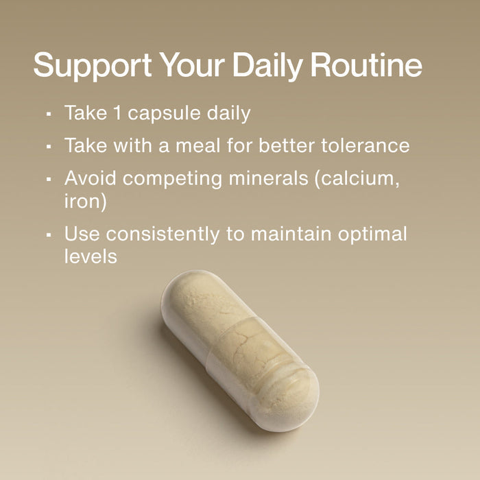 Close-up of a single capsule supplement on a beige background with text explaining how to use Zinc daily by taking one capsule with a meal and avoiding competing minerals for optimal wellness.